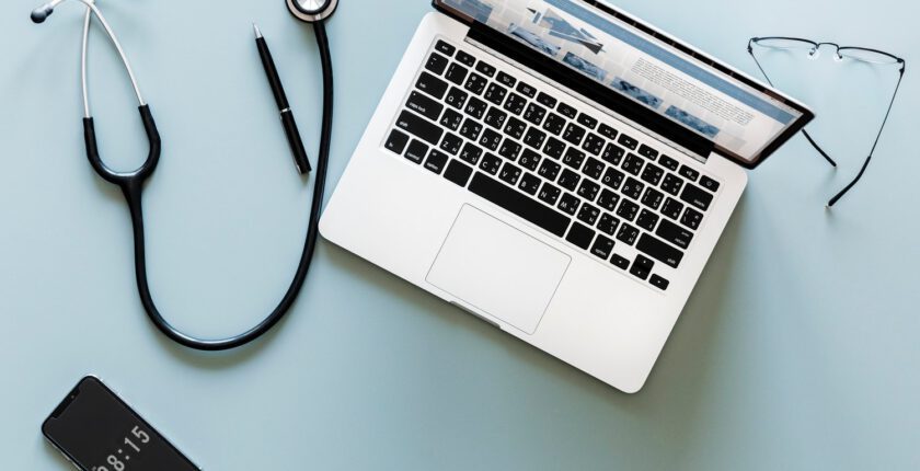 lap top and stethescope on table