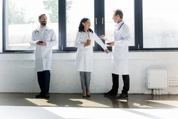 3 people standing in white coats